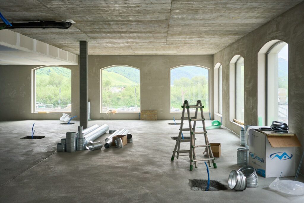 Post construction cleaning: How Commercial Cleaning Differs From Domestic Cleaning. A large room with windows and a ladder